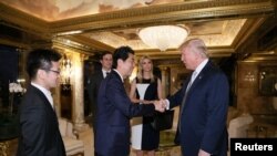 FILE - Japan's Prime Minister Shinzo Abe meets with U.S. President-elect Donald Trump (R) at Trump Tower in Manhattan, New York, U.S., Nov. 17, 2016.
