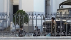 Soldiers sit inside the City Hall compound in Yangon on February 2, 2021, a day after Myanmar's military seized power in a bloodless coup, detaining democratically elected leader Aung San Suu Kyi and imposing a one-year state of emergency.