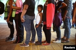 Central American migrants, moving in a caravan through Mexico toward the U.S. border, stand in line for food at a shelter set up for them by the Catholic church, in Puebla, Mexico April 6, 2018.