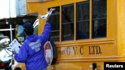 A New York City Health official hands out information on the Ebola virus, Oct. 27, 2014.