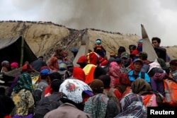 Mount Bromo spews ash as Hindu villagers and visitors gather ahead of Kasada ceremony, when villagers and worshippers throw offerings such as livestock and other crops into the volcanic crater of Mount Bromo, in Probolinggo, Indonesia, July 20, 2016.