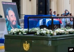 FILE - The funeral procession carrying the ashes of Fidel Castro leaves the town of Santa Clara, Cuba, Dec. 1, 2016.