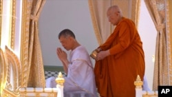 Thailand’s King Maha Vajiralongkorn, left, attends the royal purification ceremony at the Grand Palace, May 4, 2019, in Bangkok. Saturday began three days of elaborate centuries-old ceremonies for the formal coronation of Vajiralongkorn.