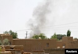 Smoke rises from a residential area where gun battle is going on between Taliban and Afghan forces in Ghazni province, Afghanistan Aug. 10, 2018.