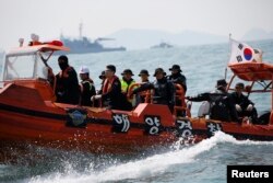 South Korean divers operate at the site where the capsized passenger ship Sewol sank in the sea off Jindo, South Korea, on April 20, 2014.