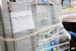 A gas station pump is wrapped up in preparation of the approaching Hurricane Lane, Aug. 24, 2018, in Waimanalo, Hawaii.