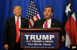 Republican presidential candidate Donald Trump smiles as he stands with New Jersey Gov. Chris Christie before a rally in Fort Worth, Texas, Feb. 26, 2016.