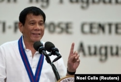 FILE - Philippine President Rodrigo Duterte gestures while delivering a speech during the 115th Police Service Anniversary at the Philippine National Police (PNP) headquarters in Quezon city, metro Manila, Philippines, Aug. 17, 2016.