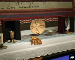 Among the objects on the altar in 'Temple for Pablo Tac' are a chalice, a medicine pouch, and eagle feathers.