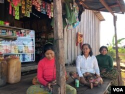 Nat Sota, a displaced villager of Lower Sesan 2, (middle), gathers with other villagers who have been affected by flooding caused by Lower Sesan 2 Dam, Stung Treng province, Nov 28, 2018. (Sun Narin/VOA Khmer)