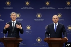 New NATO Secretary General Jens Stoltenberg, left, speaks to the media after talks with Turkey's Foreign Minister Mevlut Cavusoglu, right, in Ankara, Turkey, Oct. 9, 2014.