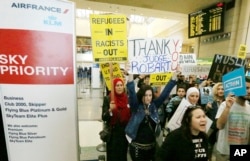 Demonstrators opposed to President Trump's travel ban march through Tom Bradley International Terminal at Los Angeles International Airport, Feb. 4, 2017. One sign thanks federal judge James L. Robart, who issued a stay of the order.