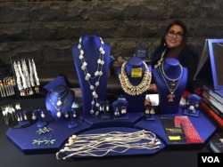 Artist Jhane Myers continues the traditions of her Comanche/Blackfeet ancestry by incorporating natural elements like animal teeth and bones into her work. (J.Taboh/VOA)