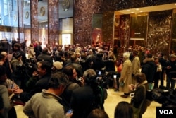 Trump campaign manager Kellyanne Conway, quite a celebrity at Trump Tower, agrees to selfie after selfie with tourists in the building's lobby in New York, Dec. 12, 2016. (R. Taylor/VOA)