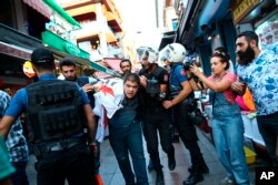 FILE - Turkish police officers arrest protesters, gathered to offer support to workers that were arrested for protesting labor conditions at Istanbul's new airport, in Istanbul, Sept. 15, 2018.
