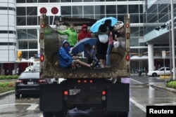 Evacuees are transported to the George R. Brown Convention Center after Hurricane Harvey inundated the Texas Gulf coast with rain causing widespread flooding, in Houston, Aug. 27, 2017.