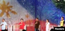 Philippine Presidential candidates sing the national anthem before the start of a April 24, 2016 presidential debate in Dagupan City.