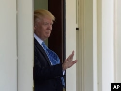 President Donald Trump waves goodbye after walking Palestinian leader Mahmoud Abbas to his car following a visit to the White House in Washington, May 3, 2017.