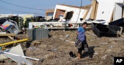 Bob Campbell walks through debris after returning home after Hurricane Harvey, in Port Aransas, Texas, Aug. 30, 2017.