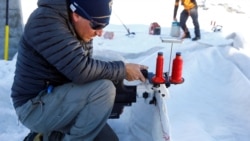 An employee of Titlis Bergbahnen sews together blankets for the coverage of parts of the glacier to protect it against melting on Mount Titlis near the Alpine resort of Engelberg, Switzerland July 2, 2021. (REUTERS/Arnd Wiegmann)