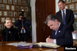 Nobel Peace Prize laureate Colombian President Juan Manuel Santos signs a protocol in the Norwegian Nobel Institute in Oslo, Norway, Friday, Dec. 9, 2016.