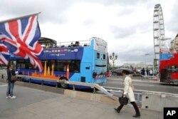 Pedestrians walk by newly installed barriers on Westminster Bridge in London, June 5, 2017.