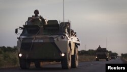 A convoy of French military vehicles drive on a road outside Markala, January 22, 2013.