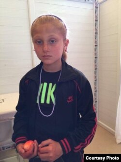 A young Yazidi girl pauses for a photo at Turkey's Diyarbakir camp. (Photo courtesy of Omer Eryılmaz)