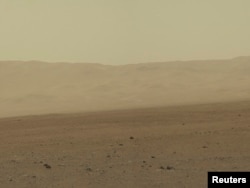 FILE - This color image taken August 8, 2012 from NASA's Curiosity rover, and released August 13, shows part of the wall of Gale Crater, the location on Mars where the rover landed on August 5, 2012.