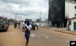 FILE - Gabonese police stand guard following an election protest in Libreville, Gabon, Sept. 1, 2016.