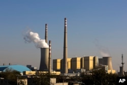 FILE - Smoke billows from a coal-fired power plant in Beijing, China, Nov. 13, 2014.