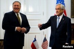 U.S. Secretary of State Mike Pompeo reacts as he stands next to Chile's President Sebastian Pinera at the presidential palace La Moneda, in Santiago, Chile, April 12, 2019.