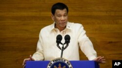 Philippine President Rodrigo Duterte gestures during his third State of the Nation Address at the House of Representatives in Quezon city, metropolitan Manila, Philippines Monday July 23, 2018. (AP Photo/Aaron Favila)