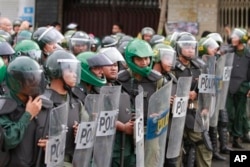 FILE - Cambodian riot policemen line up as supporters of opposition parties gather for demonstrations in Phnom Penh, Cambodia, Sept. 15, 2013.