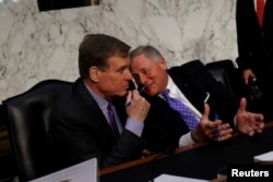 FILE - Sen. Mark Warner (D-VA) and Sen. Richard Burr (R-NC) speak following CIA Director nominee Gina Haspel testifying before the Senate Intelligence Committee on Capitol Hill in Washington, May 9, 2018.