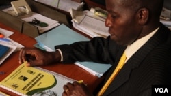 Stephen Masaba of the Uganda Wildlife Authority reviews plans to upgrade Kidepo National Park, Sept. 5, 2013. (Hilary Heuler for VOA)