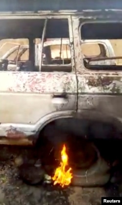 A burning vehicle is seen in a village after an attack Ogossagou, Mali, in this still image obtained from a social media video on March 24, 2019.