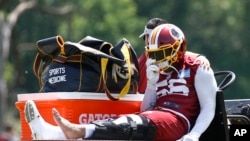 Washington Redskins linebacker Reuben Foster rides a cart off the field after suffering an injury during a practice at the team's NFL football practice facility, Monday, May 20, 2019, in Ashburn, Va. (AP Photo/Patrick Semansky)