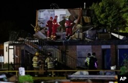 Emergency workers check what is left of the second floor of a hotel, Sunday, May 26, 2019, in El Reno, Ok., following a likely tornado touchdown late Saturday night.
