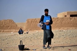 A deminer in Nad-e-Ali village in Helmand province takes a break to pray before resuming his dangerous work of removing unexploded ordnance.