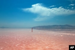 FILE - This picture taken Aug. 26, 2016, shows an Iranian spending time in Urmia Lake near Urmia, in northwestern Iran.