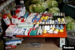 Medicines are displayed on sale in a fruit and vegetables stall at a market in Rubio, Venezuela, Dec. 5, 2017.