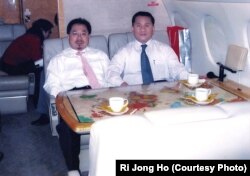 FILE - Former North Korean official, Ri Jong Ho, right, who oversaw North Korea’s overall production and trade while serving at the Office 39 for decades, heads to Pyongyang with Chinese investment tycoon Sam Pa, December 2006.