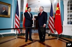 Secretary of State Rex Tillerson shakes hands with Chinese State Councilor Yang Jiechi during a photo opportunity at the State Department in Washington, Feb. 8, 2018.