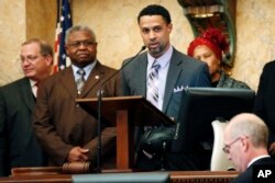 Reps. Jeffrey Guice, R-Ocean Springs, left, and Billy Broomfield, D-Moss Point, second from left, listen as former basketball player Mahmoud Abdul-Rauf expresses his thanks for being honored by the Mississippi House with a resolution noting his athletic endeavors, Feb. 26, 2013, at the Capitol in Jackson, Miss.