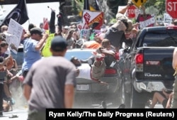 A vehicle plows into a group of protesters marching along 4th Street NE at the Downtown Mall in Charlottesville on the day of the Unite the Right rally, Aug. 12, 2017.