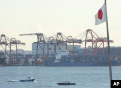 FILE - A tug boat goes by the pier of a container terminal in Tokyo, Jan. 25, 2017. Talk of a possible 20 percent tax on U.S. imports from Mexico is raising eyebrows in Asia, where exports to the U.S. drive growth in many economies.