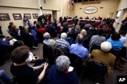 FILE - Ferguson residents pack the council chambers for a meeting of the City Council in Ferguson, Missouri, Feb. 2, 2016.