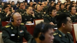 FILE - Students of the National Defense University listen as US Secretary of Defense Chuck Hagel gives a speech at the university in Beijing on April 8, 2014.