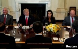FILE - U.S. President Donald Trump, seated with then-Secretary of State Rex Tillerson, U.S. Ambassador to the United Nations Nikki Haley and then-U.S. National Security Adviser H.R. McMaster, hosts a lunch for ambassadors to the United Nations Security Council, at the White House in Washington, Jan. 29, 2018.